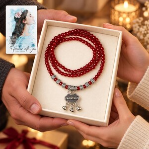 Crimson Agate style Charm Wrap Bracelet shown during a warm gift-receiving moment between adults with the jewelry visible. A personalized digital greeting card is shown alongside.
