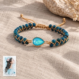 Blue Teardrop Cord Bracelet, laid on fabric. A sample personalized digital greeting card is shown alongside.