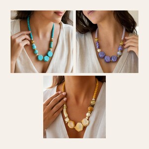 May include: Three necklaces featuring chunky geometric beads in turquoise, purple, and yellow. Each piece incorporates smaller round beads, metallic gold-toned spacers, and textured accents, creating a layered look with varied bead shapes and sizes.