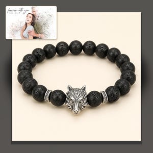 Black bead bracelet with silver-tone wolf-head detail, dark-bordered product view. A personalized greeting-card example appears in the corner.