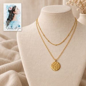Gold Tone Coin Satellite Necklace arranged on soft ivory linen in a refined neutral flat lay. A personalized digital greeting card is shown alongside.