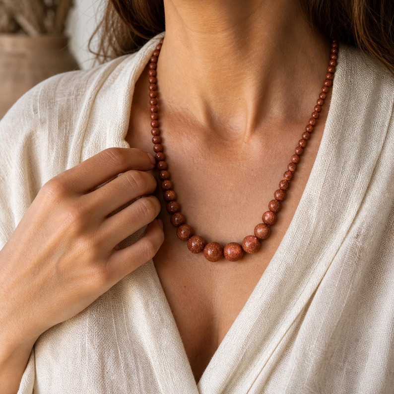 Copper and Brown Statement Beaded Necklace, Boho Handmade Jewelry, Artisan Gift for Her displayed on a jewelry bust with the layered beadwork and pendants visible