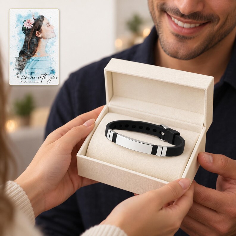 Adult man receiving an open ivory jewelry box with the black strap and polished silver-tone bar bracelet. A personalized digital greeting card is shown alongside.