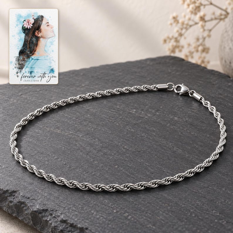 Polished silver-tone rope chain on charcoal stone style with controlled silver tone highlights. A personalized digital greeting card is shown alongside.