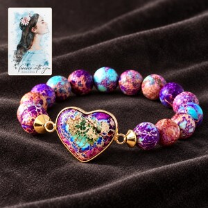 Imperial Mosaic Heart Bracelet styled against a dark luxury surface with the exact product finish clearly visible. A personalized digital greeting card is shown alongside.
