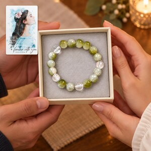 Forest Dew Bead Bracelet shown during a warm gift-receiving moment between adults with the jewelry visible. A personalized digital greeting card is shown alongside.