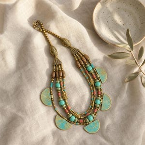 Gray and Silver Statement Beaded Necklace presented in an open jewelry gift box on natural linen