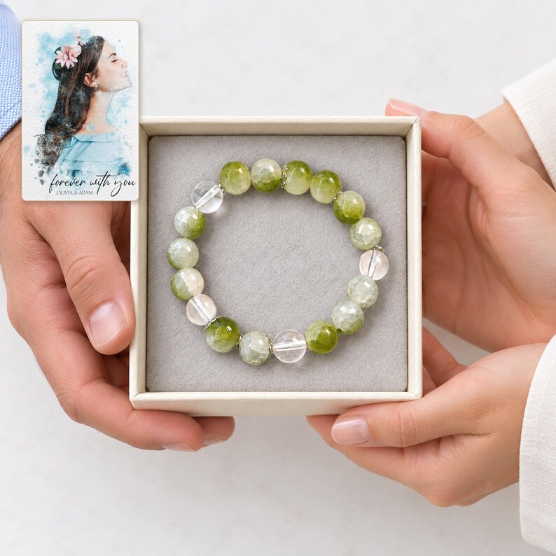 Forest Dew Bead Bracelet shown during a believable gift-giving moment between adults with the jewelry visible. A personalized digital greeting card is shown alongside.