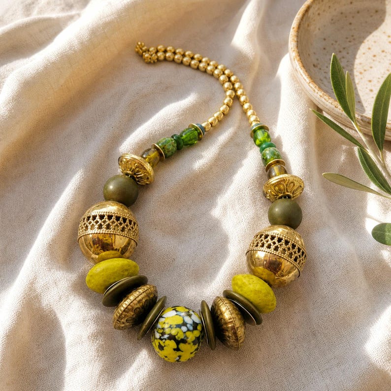 Gray and Brown Statement Beaded Necklace presented in an open jewelry gift box on natural linen