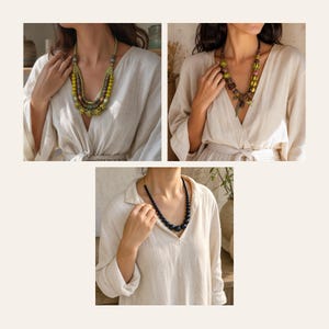 May include: A collection of three necklaces featuring different bead designs. One necklace has multi-layered green and brown beads, another features striped green and brown spherical beads, and the third is a simple strand of dark blue beads.
