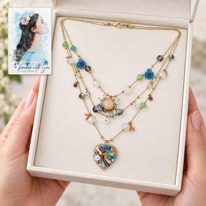 Bohemian Heart Cascade Necklace shown during a believable gift-giving moment between adults with the jewelry visible. A personalized digital greeting card is shown alongside.