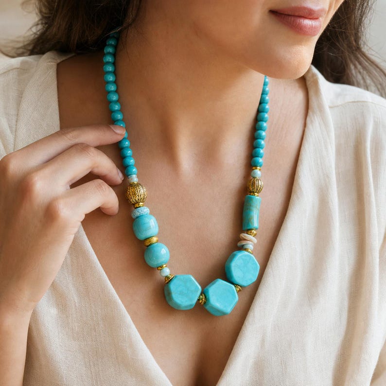 Blue and Silver Statement Beaded Necklace presented in an open jewelry gift box on natural linen