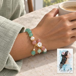 Forest Strawberry clear accents Bracelet worn by an adult in a natural daytime lifestyle scene. A personalized digital greeting card is shown alongside.
