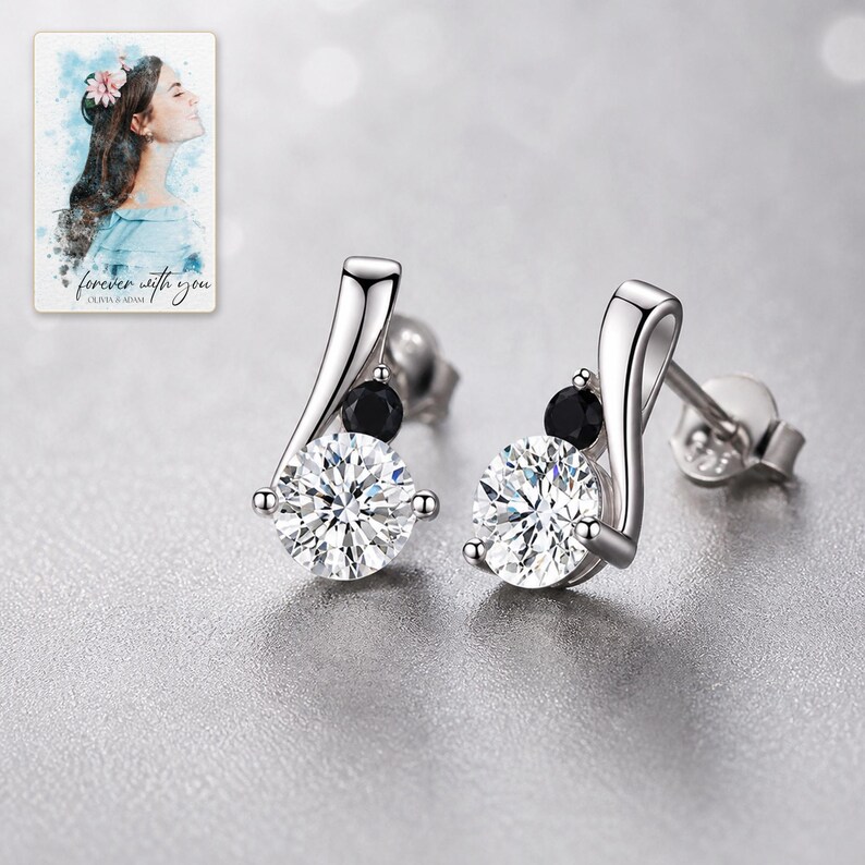 Polished sterling silver and zircon stud earrings styled with sophisticated evening lighting and fabric.