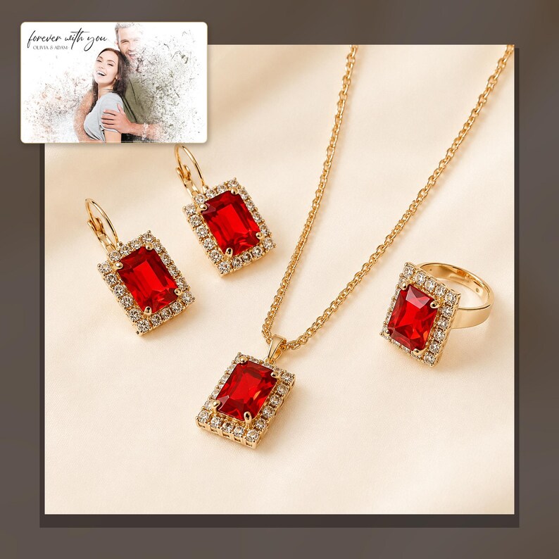 Red rectangular-stone necklace, matching earrings and ring, alternate framed view. A personalized greeting-card example appears in the corner.