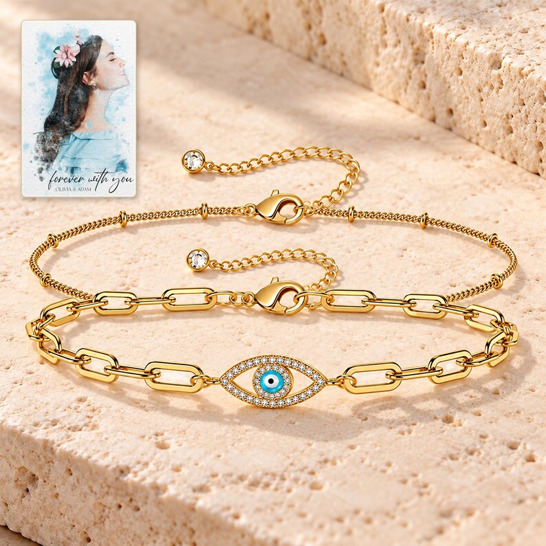 Gold Tone Evil Eye Bracelet Duo shown in a close macro view highlighting the visible, texture and construction details. A personalized digital greeting card is shown alongside.