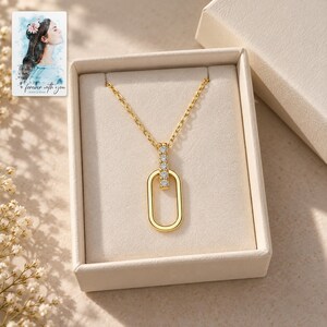 Oval Link Moissanite Necklace, displayed in a presentation box. A sample personalized digital greeting card is shown alongside.