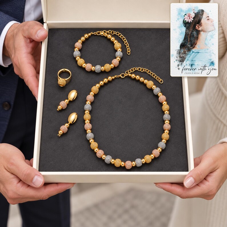 Metallic Bead Jewelry Suite shown during a believable gift-giving moment between adults with the jewelry visible. A personalized digital greeting card is shown alongside.