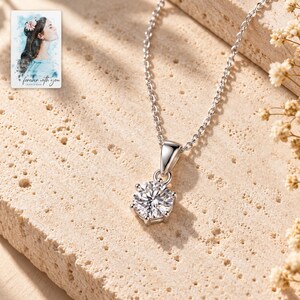 Moissanite Pendant Necklace, shown in natural light. A sample personalized digital greeting card is shown alongside.