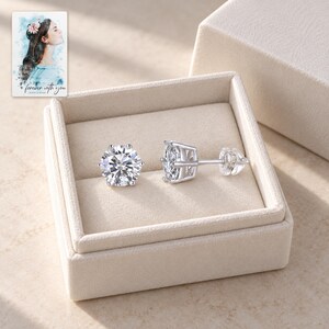 Moissanite Stud Earrings, displayed in a presentation box. A sample personalized digital greeting card is shown alongside.