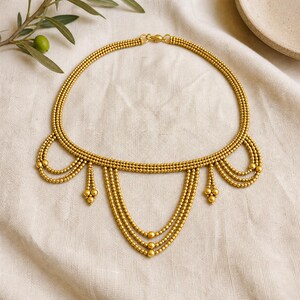 Beige and Gray Statement Beaded Necklace presented in an open jewelry gift box on natural linen