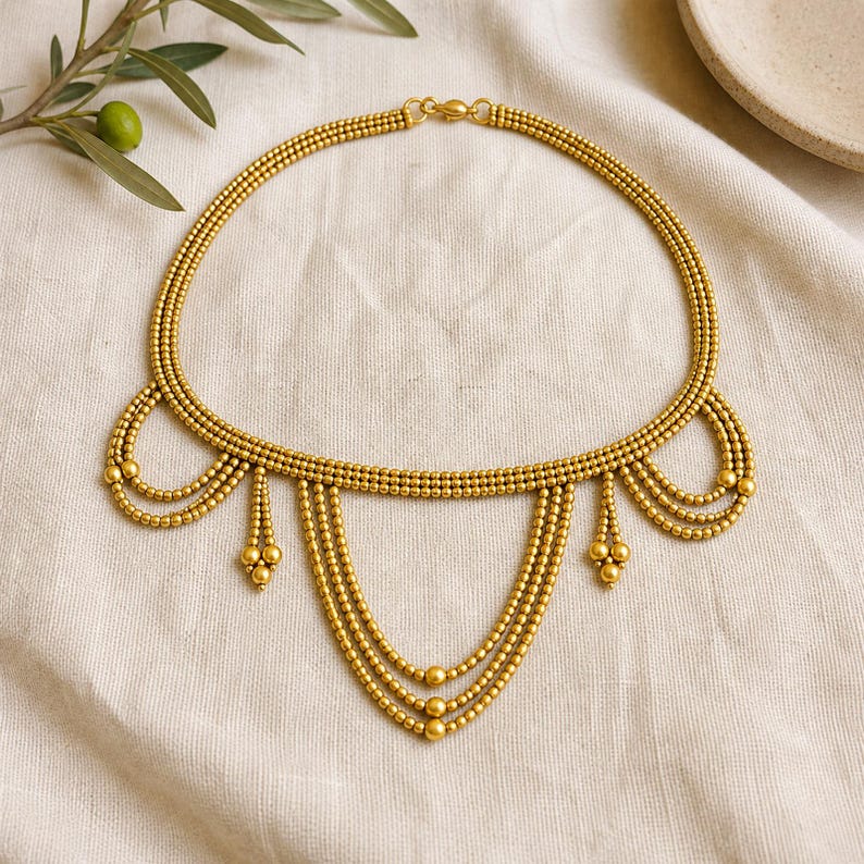 Beige and Gray Statement Beaded Necklace presented in an open jewelry gift box on natural linen