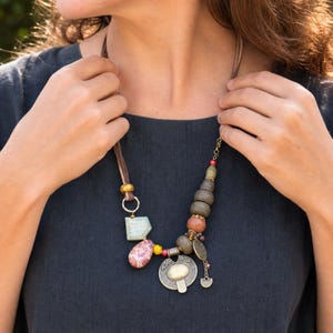 Three-piece handmade necklace set featuring gray and beige beaded necklace, rose gold and gray beaded necklace and gray and brown beaded necklace, displayed together to show the coordinated colors and beadwork