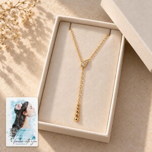 Moissanite Y Necklace, gift box view. A personalized digital greeting card is shown alongside.