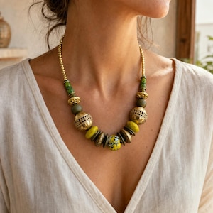 Gray and Brown Statement Beaded Necklace presented in an open jewelry gift box on natural linen