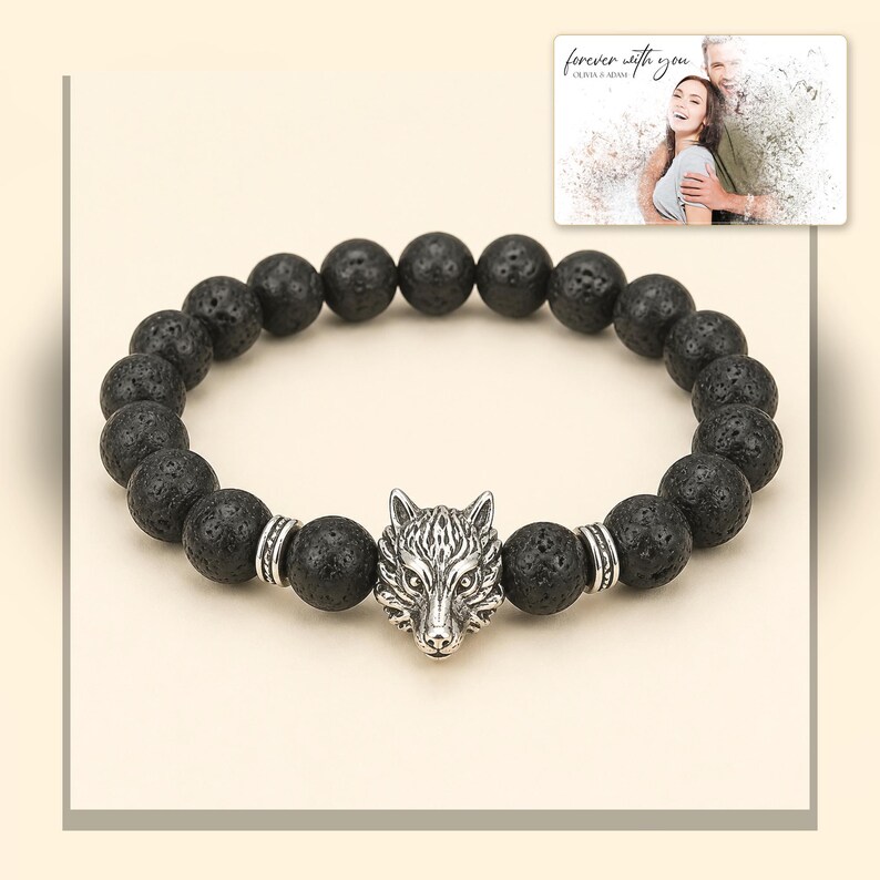 Black bead bracelet with silver-tone wolf-head detail, light-bordered product view. A personalized greeting-card example appears in the corner.