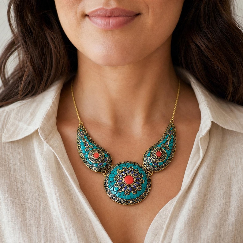 Turquoise and coral three medallion statement necklace with antique gold chain displayed on a jewelry bust with the layered beadwork and pendants visible