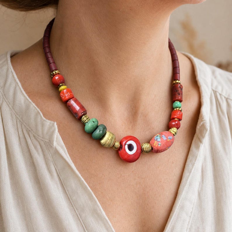 Red Evil Eye Beaded Necklace displayed on a jewelry bust, showing the necklace shape and artisan bead details