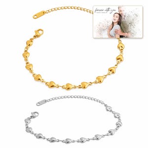 Linked Hearts Steel Bracelet shown during a believable gift-giving moment between adults with the exact jewelry visible.