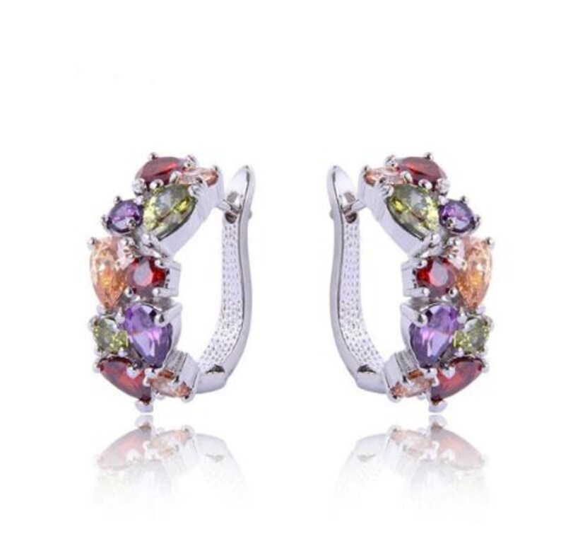 Pair of silver-tone hoop earrings with red, green, purple and clear decorative stones on a white background.
