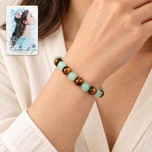 Forest Amber Bead Bracelet worn by an adult model for styling and everyday styling. A personalized digital greeting card is shown alongside.
