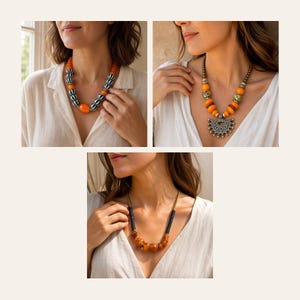 May include: A collection of three necklaces featuring orange and black beads. One necklace has black and white striped beads, another includes a silver-toned fan-shaped pendant, and the third displays a mix of dark beads and amber-colored spheres.