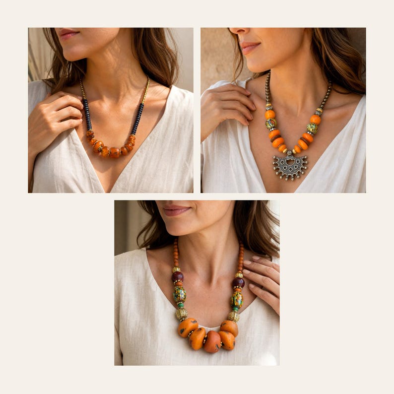 May include: Three necklaces featuring various bead designs. The first has dark cylindrical beads and amber-coloured round beads. The second features orange round beads and a silver-toned semi-circular pendant. The third displays multi-coloured patterned beads, brown spheres, and large orange beads.
