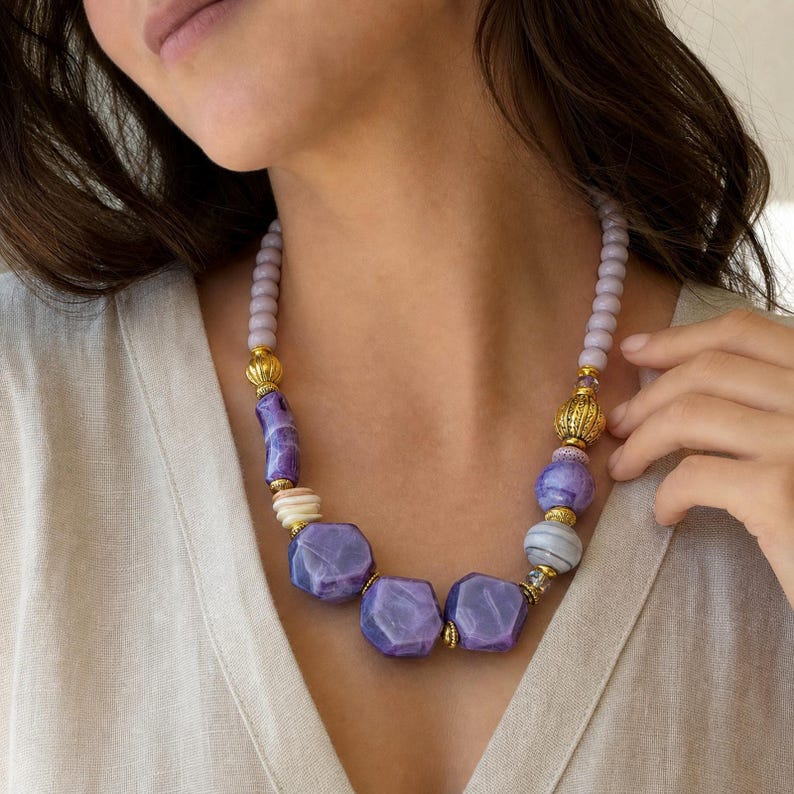 Purple and Lavender Statement Beaded Necklace presented in an open jewelry gift box on natural linen