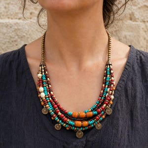 Three-piece handmade necklace set featuring beige and brown beaded necklace, brown and bronze beaded necklace and rose gold and silver beaded necklace, displayed together to show the coordinated colors and beadwork