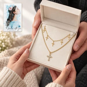 Golden Faith Layered Cross Necklace shown during a warm gift-receiving moment between adults with the jewelry visible. A personalized digital greeting card is shown alongside.