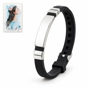 White-background view of the black strap bracelet showing its silver-tone bar, segmented end accents and adjustable fastening. A personalized digital greeting card is shown alongside.