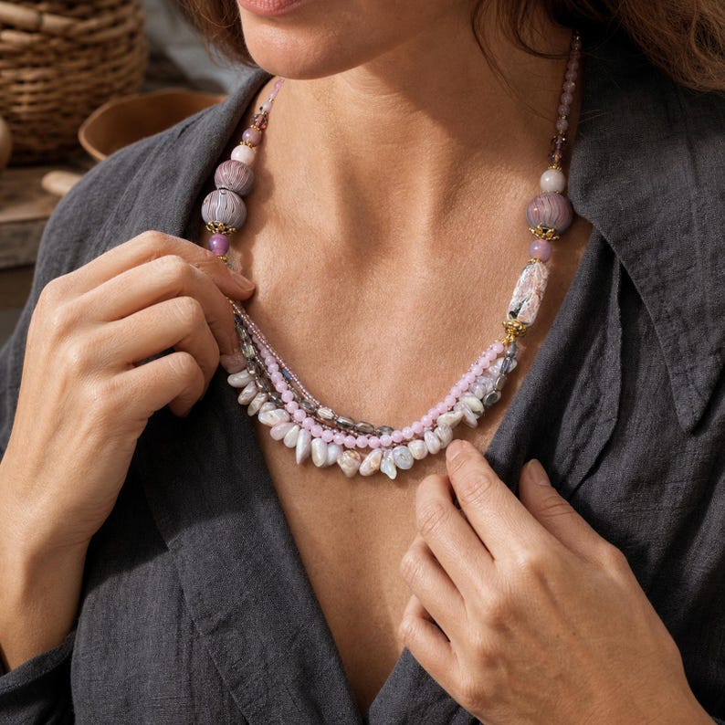 Three-piece handmade necklace set featuring bronze and beige beaded necklace, brown and bronze beaded necklace and gray and bronze beaded necklace, displayed together to show the coordinated colors and beadwork