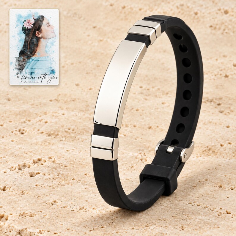 Black strap bracelet with a plain polished silver-tone curved bar standing on ivory stone style. A personalized digital greeting card is shown alongside.