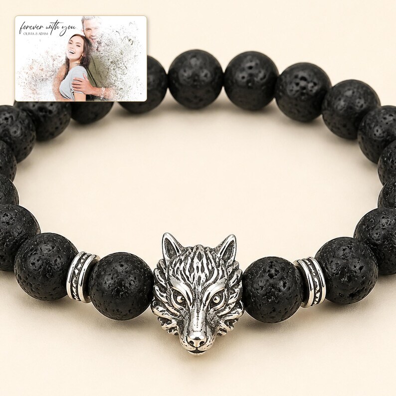 Black bead bracelet with silver-tone wolf-head detail, close detail view. A personalized greeting-card example appears in the corner.