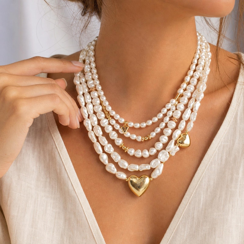 Silver and Beige Statement Beaded Necklace, Boho Handmade Jewelry, Artisan Gift for Her displayed on a jewelry bust with the layered beadwork and pendants visible