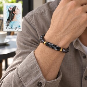 Midnight Marble Bar Bracelet worn by an adult in a natural daytime lifestyle scene. A personalized digital greeting card is shown alongside.