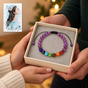 Violet Spectrum Cord Bracelet shown during a warm gift-receiving moment between adults with the jewelry visible. A personalized digital greeting card is shown alongside.