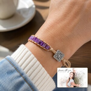 Purple rectangular-bead cord bracelet with a square decorative detail, adult lifestyle view. A personalized greeting-card example appears in the corner.