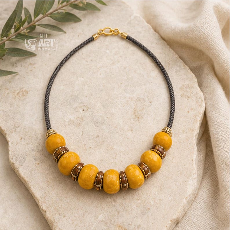Main product photo of mustard yellow beaded boho statement necklace displayed in a clean Etsy studio composition
