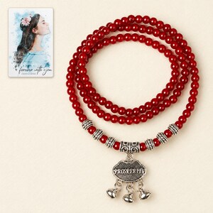 Crimson Agate style Charm Wrap Bracelet shown in a close macro view highlighting the visible texture, texture and construction details. A personalized digital greeting card is shown alongside.
